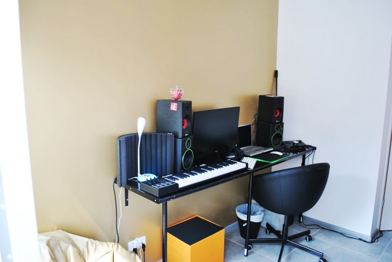 Zdjęcie przedstawia wyremontowany pomieszczenie. Na pierwszym planie znajduje się biurko ze sprzętem komputerowym i muzycznym.